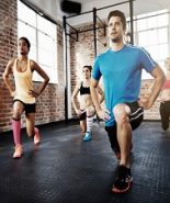 Shot of a diverse group of individuals doing lunges in a gym